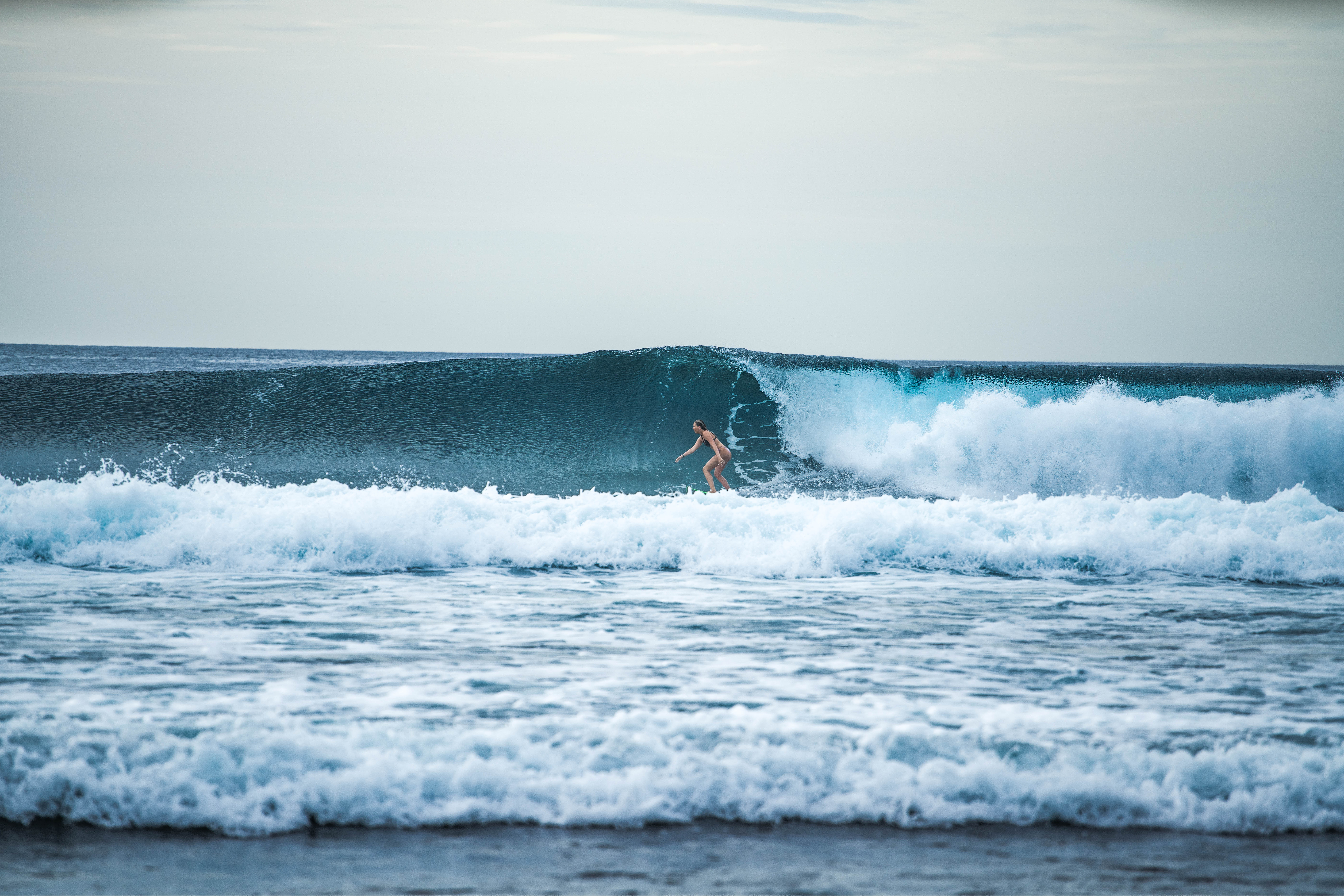 Surfer riding a wave near Thimarafushi